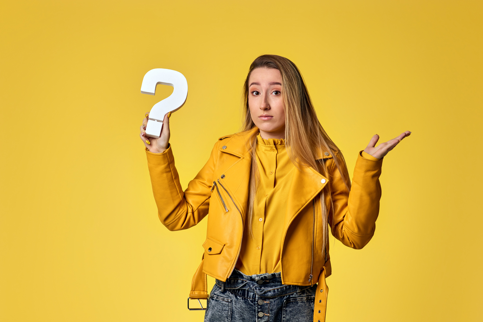 Beautiful Woman with Question Mark on Studio Background