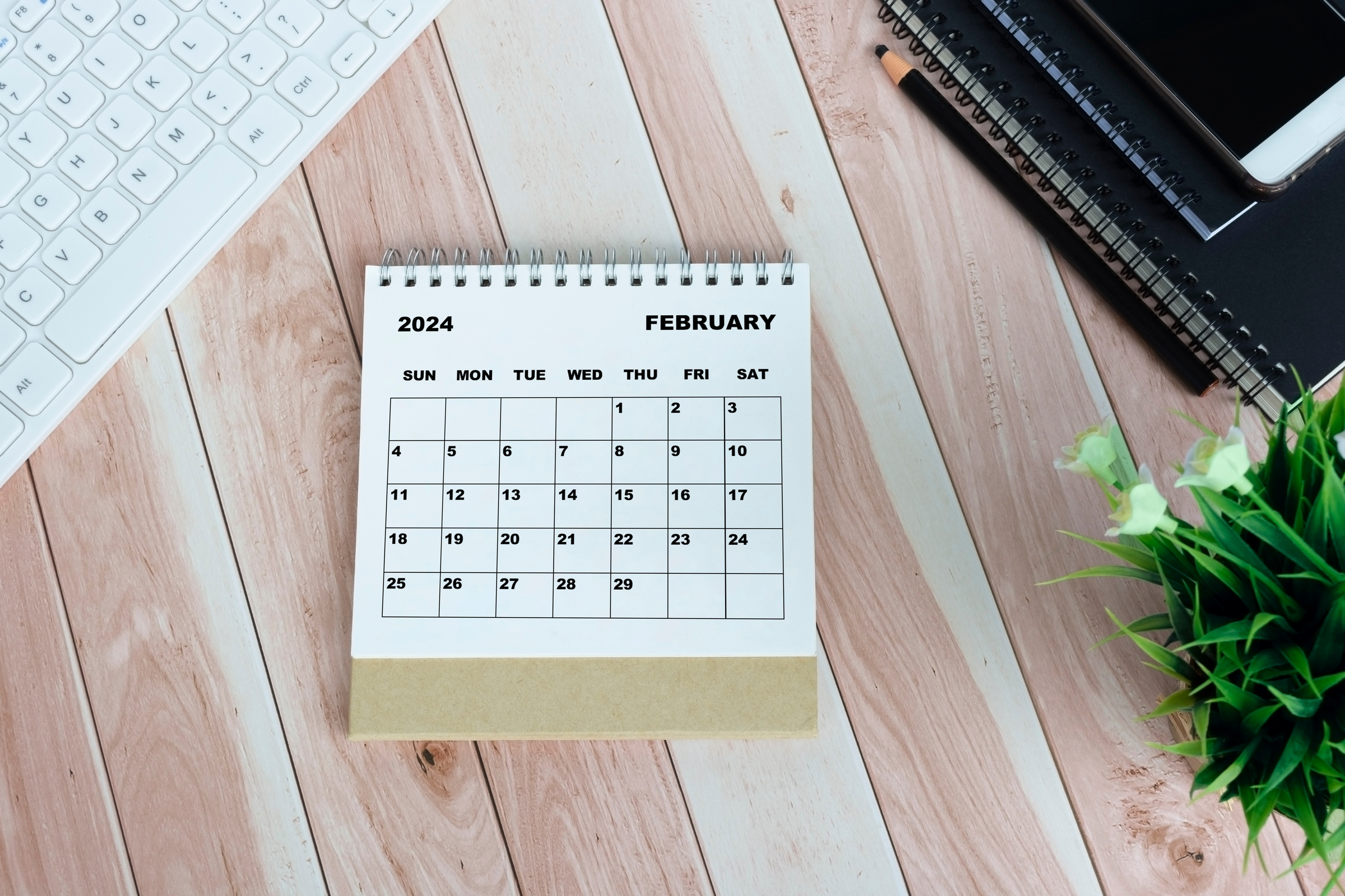 White January 2024 calendar on office wooden desk