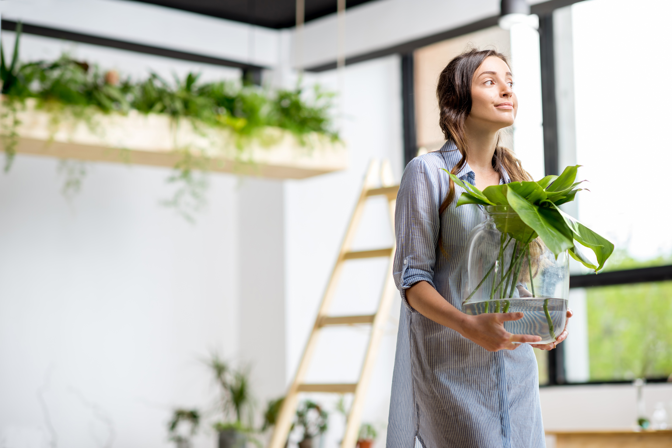 Woman with plant at home